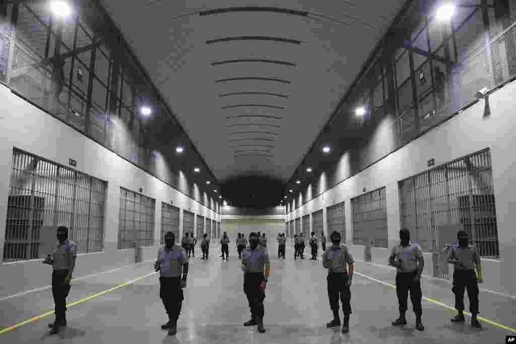 Civil guards from the General Directorate of Prisons stand outside holding cells at The Terrorism Confinement Center during a media tour in Tecoluca, El Salvador, Feb. 2, 2023.&nbsp;The &quot;mega-prison&quot; still under construction has a maximum capacity of 40,000 and is intended to imprison gang members, according to the government.&nbsp;