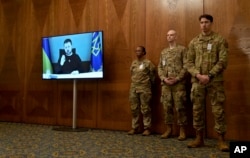 US soldiers attend the opening speech of the President of Ukraine, Volodymyr Zelenskyy, (on video screen) during the meeting of the Ukraine Security Contact Group at Ramstein Air Base in Ramstein, Germany, Jan. 20, 2023.