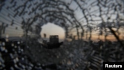 FILE - A building is seen through a bullet hole in a window of the Africa Hotel in the town of Shire, Tigray region, Ethiopia, March 16, 2021.