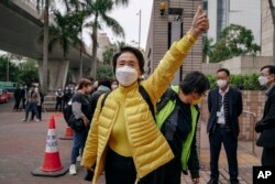 Pro-democracy activist Emily Lau Wai-hing gestures as she arrives at the West Kowloon Magistrates' Courts in Hong Kong, Monday, Feb. 6, 2023.