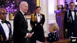 President Joe Biden and first lady Jill Biden arrive in the East Room of the White House following a dinner reception for the governors and their spouses, in Washington, Feb. 11, 2023. 