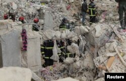Members of the Algerian rescue team search for survivors at the site of a damaged building, in the aftermath of the earthquake in Aleppo, Syria, Feb. 8, 2023.
