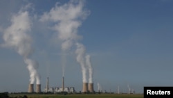 FILE - Smoke billows from the cooling towers of Kriel and Matla Power Stations, coal-fired stations of South African utility Eskom, Jan. 17, 2023.