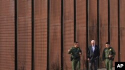 President Joe Biden walks with US Border Patrol agents along a stretch of the US-Mexico border in El Paso Texas, Jan. 8, 2023. 