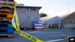 Police tape marks off the scene of a shooting off Cabrillo Highway, Jan. 24, 2023, after a gunman killed several people at two agricultural businesses in Half Moon Bay, California. (AP Photo/ Aaron Kehoe)
