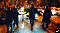 FILE - Women protest the death of Mahsa Amini, 22, who was detained by the morality police, in Tehran, Oct. 1, 2022, in this photo taken by an individual not employed by the Associated Press and obtained by the AP outside Iran.
