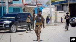 FILE - Security forces patrol at the scene, after gunmen stormed the Hayat Hotel in the capital Mogadishu, Somalia, Aug. 21, 2022. Somalia has launched what is being called the most significant military offensive against the al-Shabab extremist group in more than a decade.