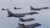 FILE - In this photo provided by South Korean Defense Ministry, U.S. Air Force B-1B bombers, center, F-22 fighter jets and South Korean Air Force F-35 fighter jets, bottom, fly during a joint air drill in South Korea, Jan. 1, 2023. 