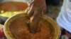 Rose Felicien, 62, mashes baked pumpkin while preparing traditional soup joumou, in the Delmas district of Port-au-Prince, Haiti, Feb. 5, 2023.