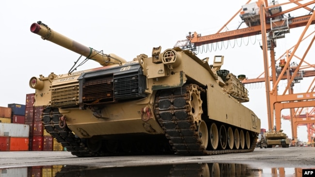 FILE - A U.S. M1A2 Abrams battle tank intended for use during military exercises by the 2nd Armored Brigade Combat Team, is unloaded at the Baltic Container Terminal in Gdynia, Poland, Dec. 3, 2022.