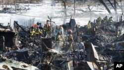 Firefighters clean up the site of a fire at Guryong village in Seoul, South Korea, Jan. 20, 2023. 
