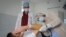 FILE - Ukrainian doctor Oleh Duda, centre, examines a patient at the hospital in western city of Lviv, Ukraine, Nov. 26, 2022. 