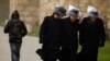 FILE - Ultra Orthodox Jewish men wear plastic bags over their hats, as they walk outside Jerusalem's old city, Dec. 12, 2010.
