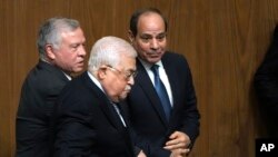 Egyptian President Abdel-Fattah el-Sissi, right, greets Palestinian President Mahmoud Abbas, center, and King Abdullah II of Jordan, during a conference to support Jerusalem at the Arab League headquarters in Cairo, Feb. 12, 2023.