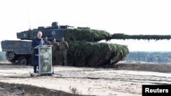 FILE - German Chancellor Olaf Scholz delivers a speech in front of a Leopard 2 tank during a visit to a military base of the German army Bundeswehr in Bergen, Germany, Oct. 17, 2022. 