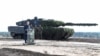 FILE - German Chancellor Olaf Scholz delivers a speech in front of a Leopard 2 tank during a visit to a military base of the German army Bundeswehr in Bergen, Germany, Oct. 17, 2022. 