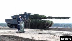 FILE - German Chancellor Olaf Scholz delivers a speech in front of a Leopard 2 tank during a visit to a military base of the German army Bundeswehr in Bergen, Germany, Oct. 17, 2022. 