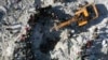 Rescuers and residents search through the rubble of collapsed buildings in the town of Harem near the Turkish border, Idlib province, Syria, Feb. 8, 2023. 