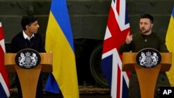 British Prime Minister Rishi Sunak, left, and Ukrainian President Volodymyr Zelenskyy hold a news conference at a military facility in Lulworth, Dorset, England, Feb. 8, 2023.