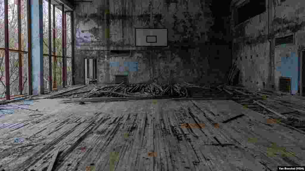 A basketball court inside one of the buildings abandoned in Prypiat. Russian soldiers took over the place after invading Ukraine and stayed for almost two months there.&nbsp;In Chernobyl, in Ukraine, Jan. 31, 2023 (VOANEWS/Yan Boechat)