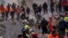 Firefighters and rescue personnel search for survivors in the rubble of a destroyed building in Adana, southern Turkey, Feb. 8, 2023.