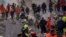 Firefighters and rescue personnel search for survivors in the rubble of a destroyed building in Adana, southern Turkey, Feb. 8, 2023.