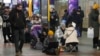 People gather in a subway station being used as a bomb shelter during a rocket attack in Kyiv, Ukraine, Jan. 26, 2023.