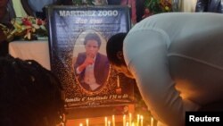 FILE - Journalists pay their last respects to colleague Martinez Zogo, who was found dead after being abducted, in Yaounde, Cameroon, Jan. 23, 2023.