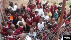 Students, visibly excited, are seen gathered at their school's opening, at Michiru View School in Blantyre, Malawi. (Lameck Masina/VOA)
