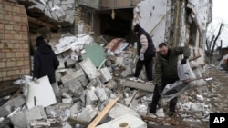 People check a destroyed house after a Russian rocket attack in Hlevakha, Kyiv region, Ukraine, Jan. 26, 2023.