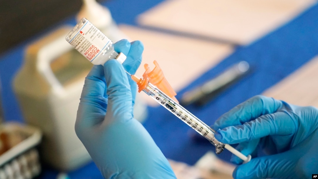 FILE - A nurse prepares a syringe of a COVID-19 vaccine at an inoculation station in Jackson, Mississippi, July 19, 2022.