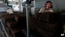 Employees work at a rubber industrial plant of the cooperative called Cooperacre, in Sena Madureira, Acre state, Brazil, Dec. 9, 2022.