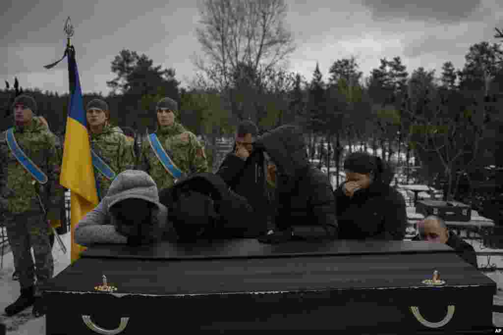 Relatives mourn by the coffin of Eduard Strauss, a Ukrainian serviceman who died in combat on Jan. 17 in Bakhmut, during his funeral in Irpin.