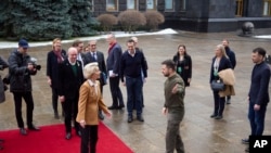 Ukrainian President Volodymyr Zelenskyy, center right, and European Commission President Ursula von der Leyen greet each other during the EU-Ukraine summit in Kyiv, Ukraine, Feb. 2, 2023, in this photo provided by the Ukrainian Presidential Press Office.