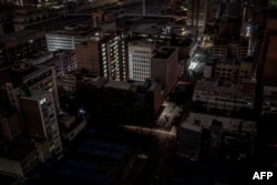 FILE - Parts of the Braamfontein area of Johannesburg, South Africa, are submerged in darkness due to load-shedding rolling blackout on Jan. 31, 2023.