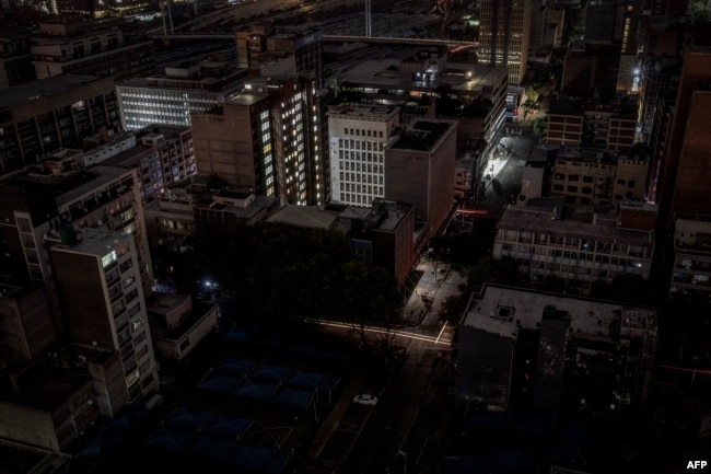 FILE - Parts of the Braamfontein area of Johannesburg, South Africa, are submerged in darkness due to load-shedding rolling blackout on Jan. 31, 2023.