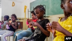 FILE - Children take refuge at a Catholic school in Port-au-Prince, Haiti, on July 30, 2022, after escaping gang violence in the Cité Soleil area.