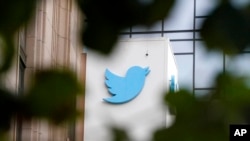 FILE - A sign at Twitter headquarters is shown in San Francisco, Dec. 8, 2022. 