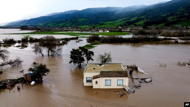 FILE - Floodwaters surround a home in the Chualar community of Monterey County, Calif., as the Salinas River overflows its banks, Jan. 13, 2023.