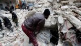 Syrian Civil Defense workers and security forces search through the wreckage of buildings, in Aleppo, Syria, Monday, February 6, 2023. (AP Photo/Omar Sanadiki)