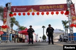 Police officers guard the area near the location of a shooting that took place during a Chinese Lunar New Year celebration, in Monterey Park, California, Jan. 22, 2023.