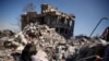 A man sits among rubble in the aftermath of a deadly earthquake in Kahramanmaras, Turkey, Feb. 11, 2023. 