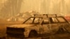 A burnt car is seen in an area consumed by wildfires in Santa Juana, Concepcion province, Chile, Feb. 5, 2023.