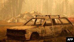 A burnt car is seen in an area consumed by wildfires in Santa Juana, Concepcion province, Chile, Feb. 5, 2023.