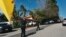 Police block the street to a house where three people were killed and four others wounded in a shooting at a short-term rental home in an upscale Los Angeles, California, neighborhood on Jan. 28, 2023.