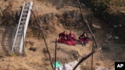 Buddhist monks pray for the plane crash victims at the crash site in Pokhara, Nepal, Jan. 18, 2023.