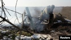 A Ukrainian serviceman fires a mortar shell towards Russian troops at the frontline position near the Vuhledar town, amid Russia's attack on Ukraine, in Donetsk region, Ukraine, Feb. 11, 2023.