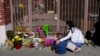 A woman comforts her son while visiting a makeshift memorial outside Star Dance Studio in Monterey Park, California, Jan. 23, 2023. 