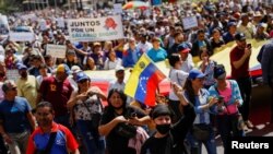 FILE - Demonstrators, including teachers, health workers, trade unions members and opposition activists march to demand higher wages as they protest against the government of President Nicolas Maduro, in Caracas, Venezuela, Jan. 23, 2023.