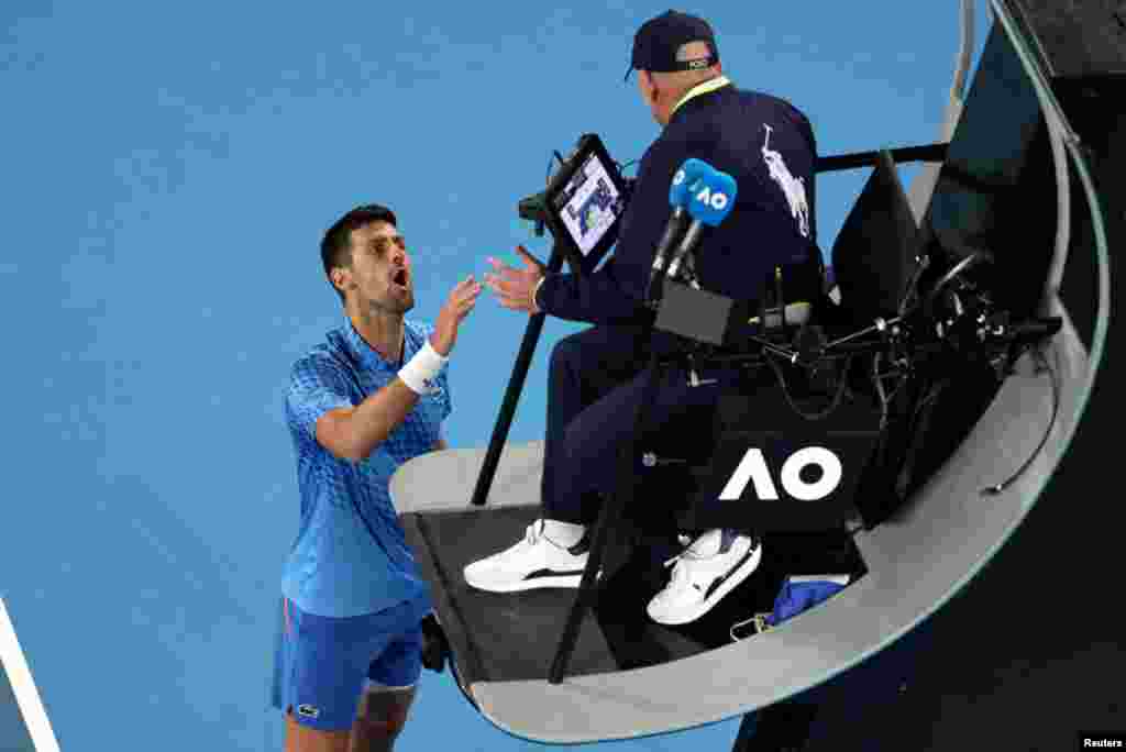 Serbia&#39;s Novak Djokovic argues with the umpire during his second round match against France&#39;s Enzo Couacaud, during the Australian Open, in Melbourne Park, Melbourne, Australia.